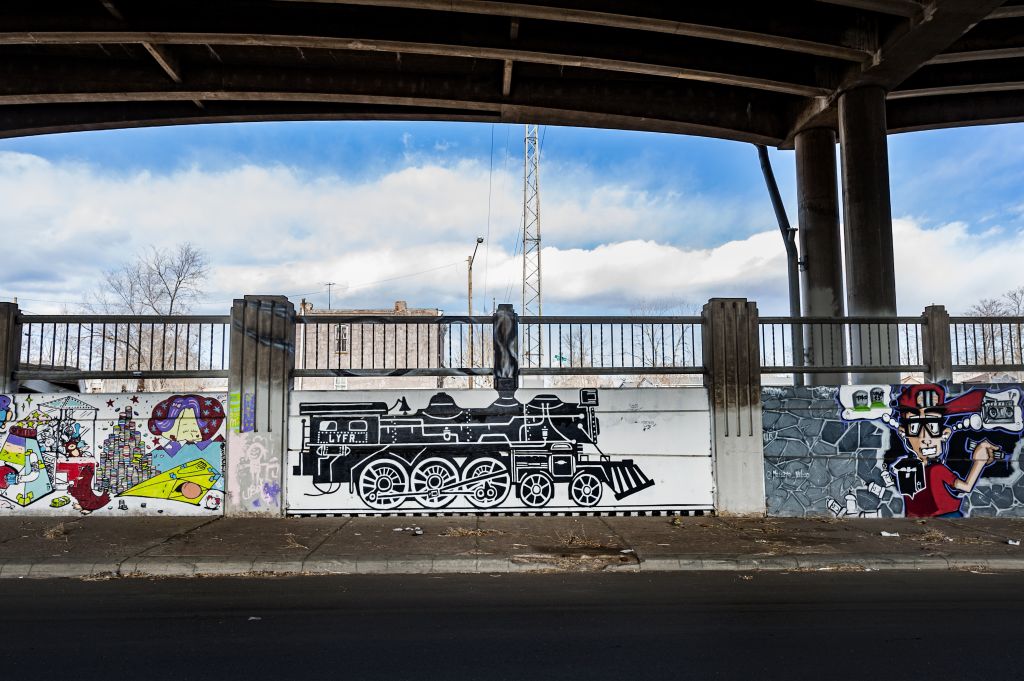 Go to the Untitled (two murals - black and white locomotive engine, boy holding a boom box) page